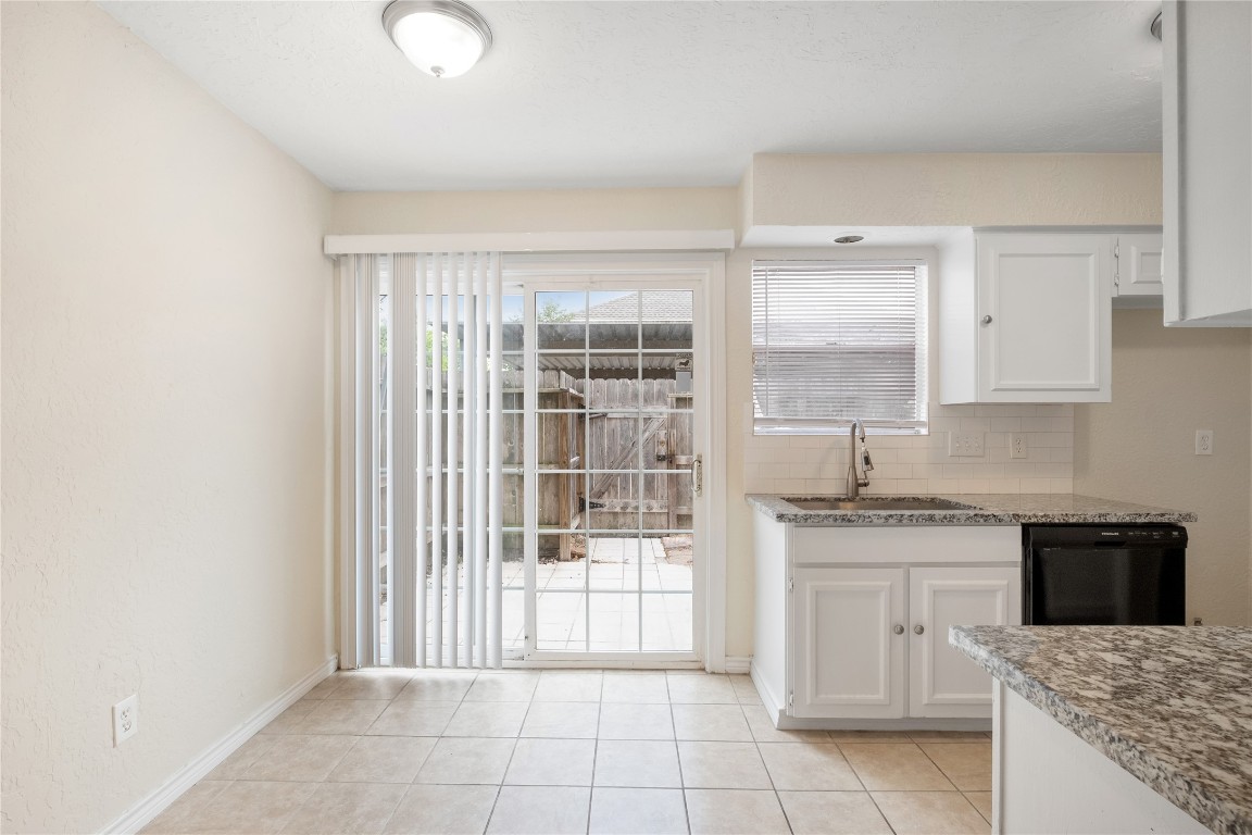 14759 Perthshire Road Houston, TX 77079 - Photo 4 of 9 a kitchen with granite countertop a sink stove and cabinets