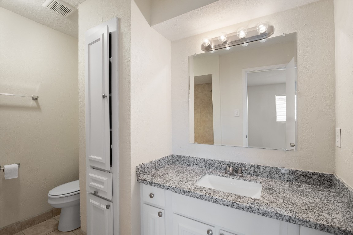 14759 Perthshire Road Houston, TX 77079 - Photo 7 of 9 a bathroom with a granite countertop sink toilet and shower