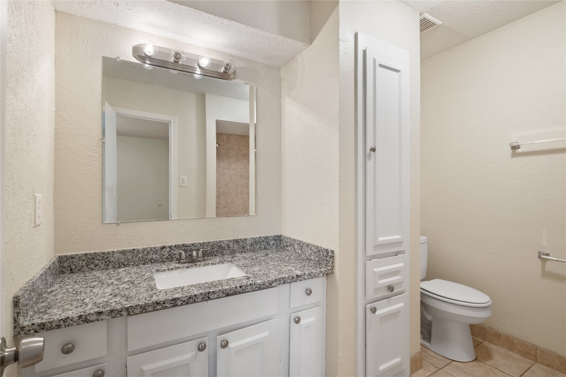 14759 Perthshire Road Houston, TX 77079 - Photo 9 of 9 a bathroom with a granite countertop sink and a mirror