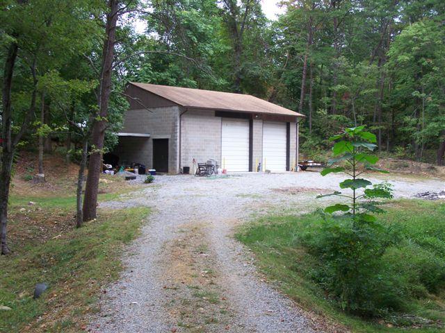 462 Leonard Farm Road Blue Ridge, VA 24064 - Photo 6 of 7 a backyard of a house with table and chairs