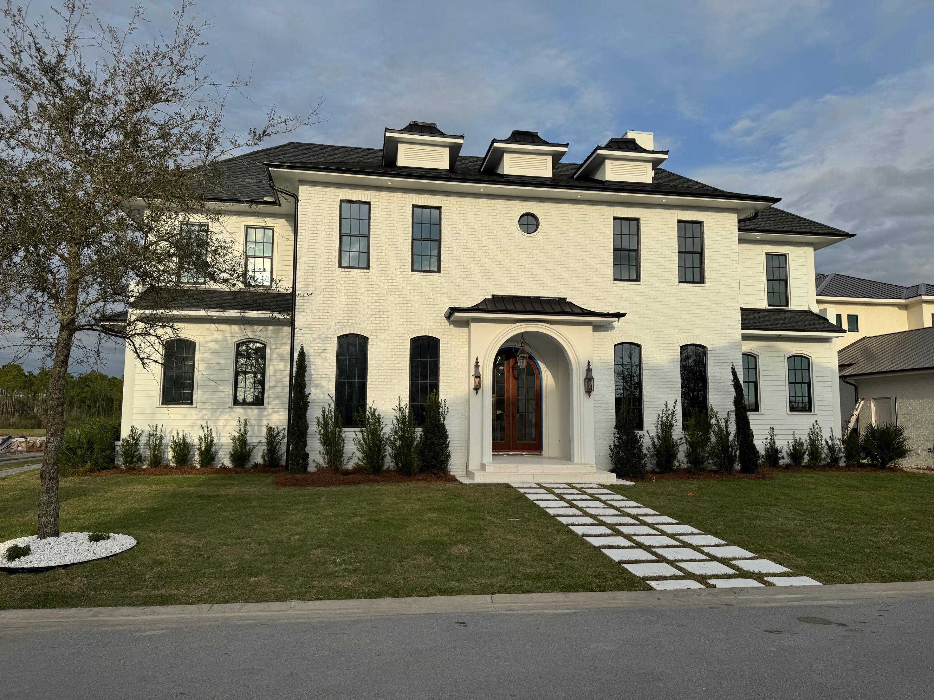 a front view of a house with garden