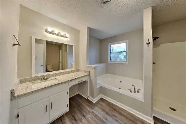 a bathroom with a bathtub and a sink