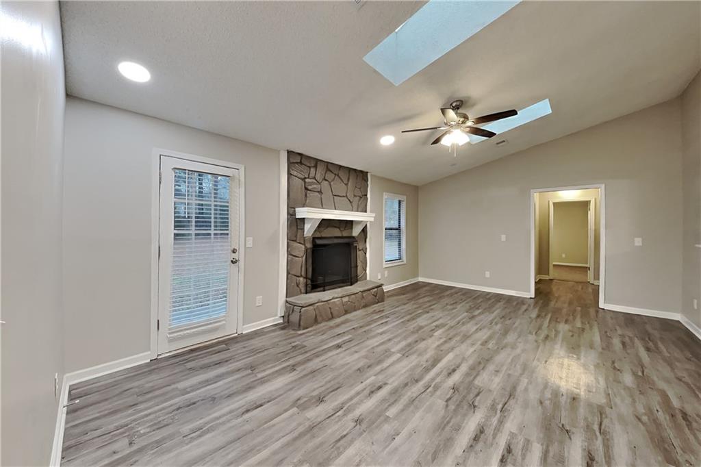 2788 Water Valley Road Austell, GA 30106 - Photo 2 of 20 a view of empty room with wooden floor and fireplace