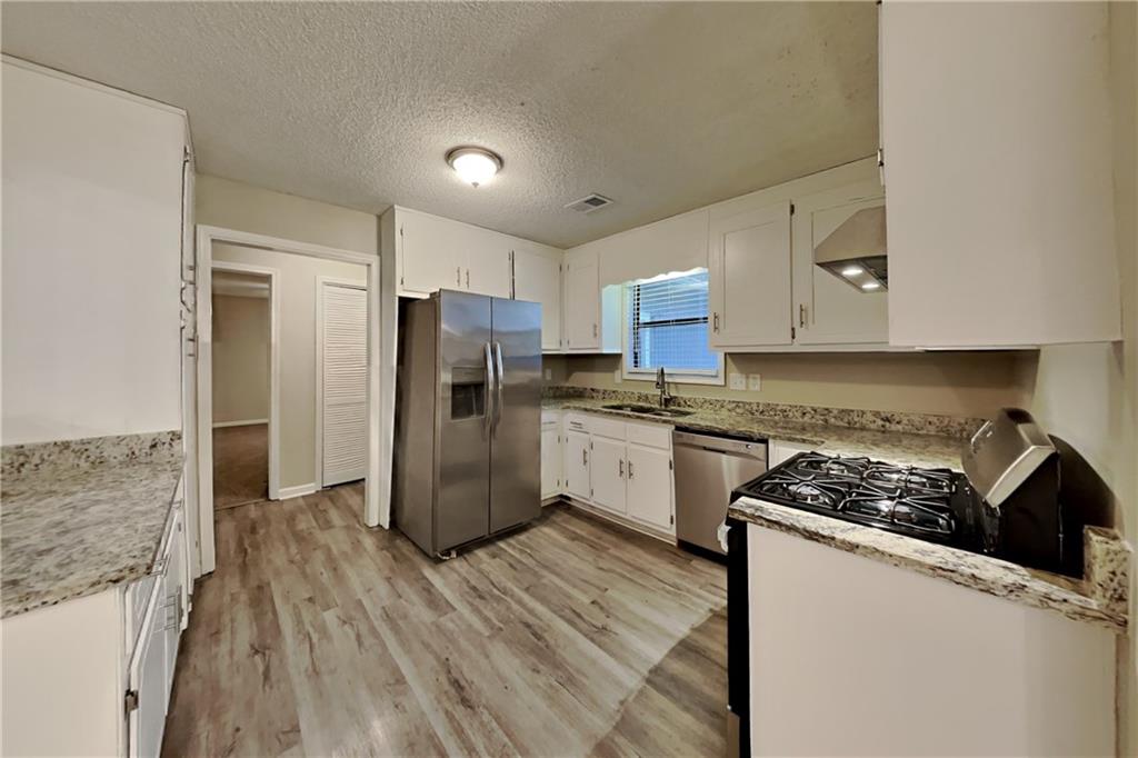 2788 Water Valley Road Austell, GA 30106 - Photo 4 of 20 a kitchen with a refrigerator and a stove top oven