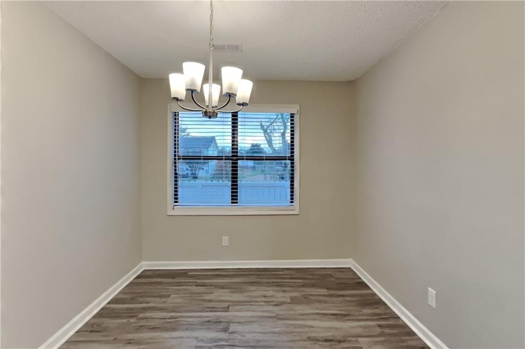 2788 Water Valley Road Austell, GA 30106 - Photo 7 of 20 a view of a room with wooden floor and chandelier