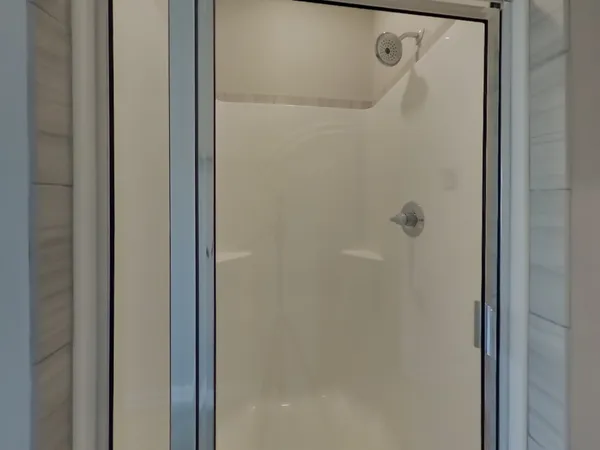 a bathroom with a glass shower door
