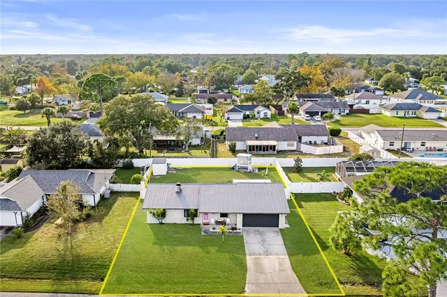 a front view of a house with a garden and yard