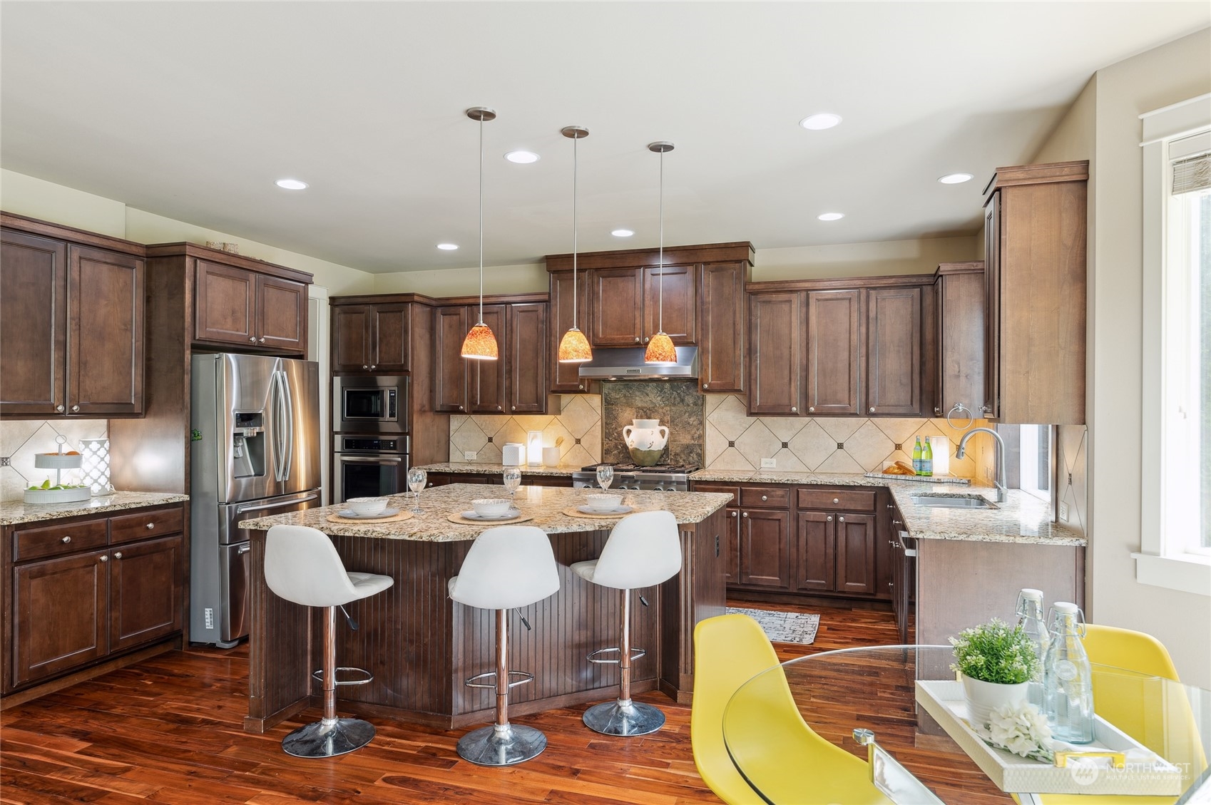 10719 Elliston Way Northeast Redmond, WA 98053 - Photo 11 of 39 a kitchen with refrigerator and chairs