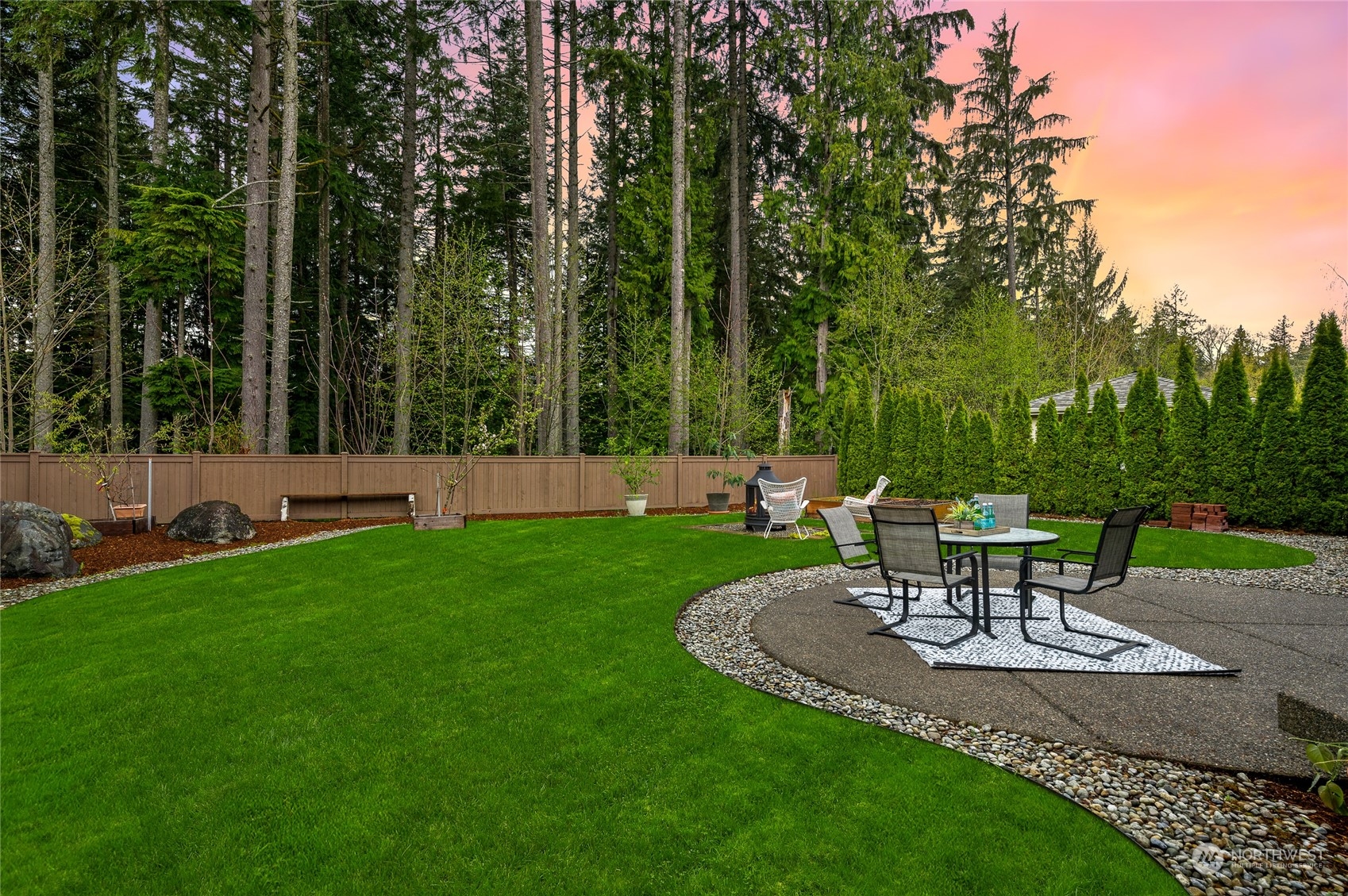 10719 Elliston Way Northeast Redmond, WA 98053 - Photo 30 of 39 a view of a garden with a bench