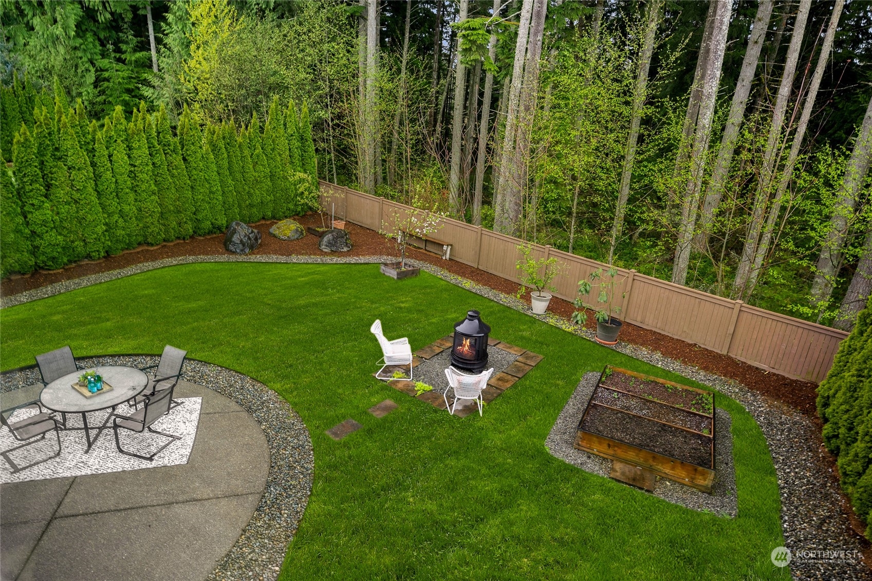 10719 Elliston Way Northeast Redmond, WA 98053 - Photo 33 of 39 a view of a table and chairs in the garden