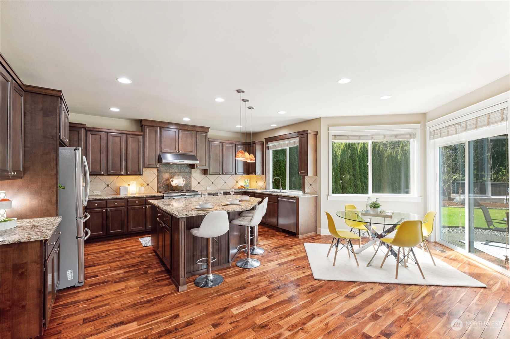 10719 Elliston Way Northeast Redmond, WA 98053 - Photo 9 of 39 a living room with stainless steel appliances granite countertop furniture wooden floor and a rug