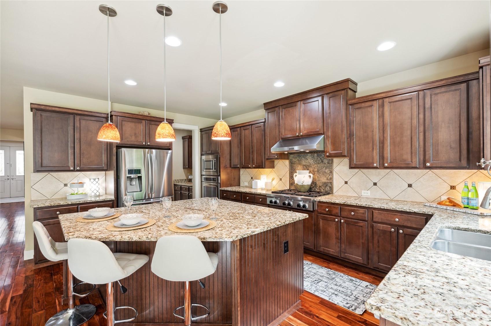 10719 Elliston Way Northeast Redmond, WA 98053 - Photo 10 of 39 a kitchen with granite countertop a sink and cabinets