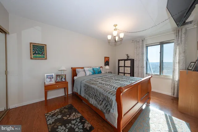 a bed room with a bed and a chandelier