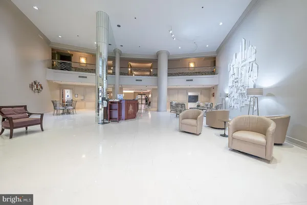 a living room with furniture kitchen view and a chandelier