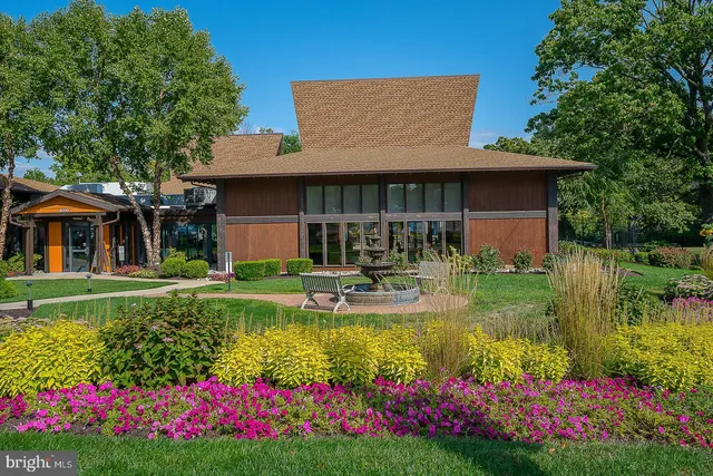 a view of house with swimming pool and garden