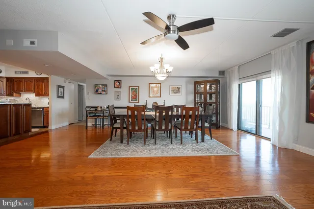 a view of dining room with wooden floor and window