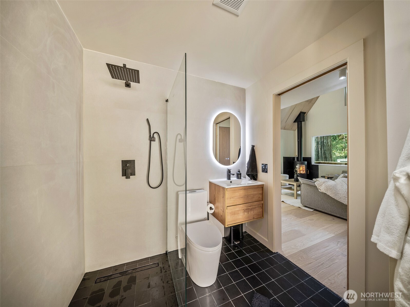 64258 Lookout Mtn Loop Marblemount, WA 98267 - Photo 22 of 40 a living room with furniture a mirror and a toilet