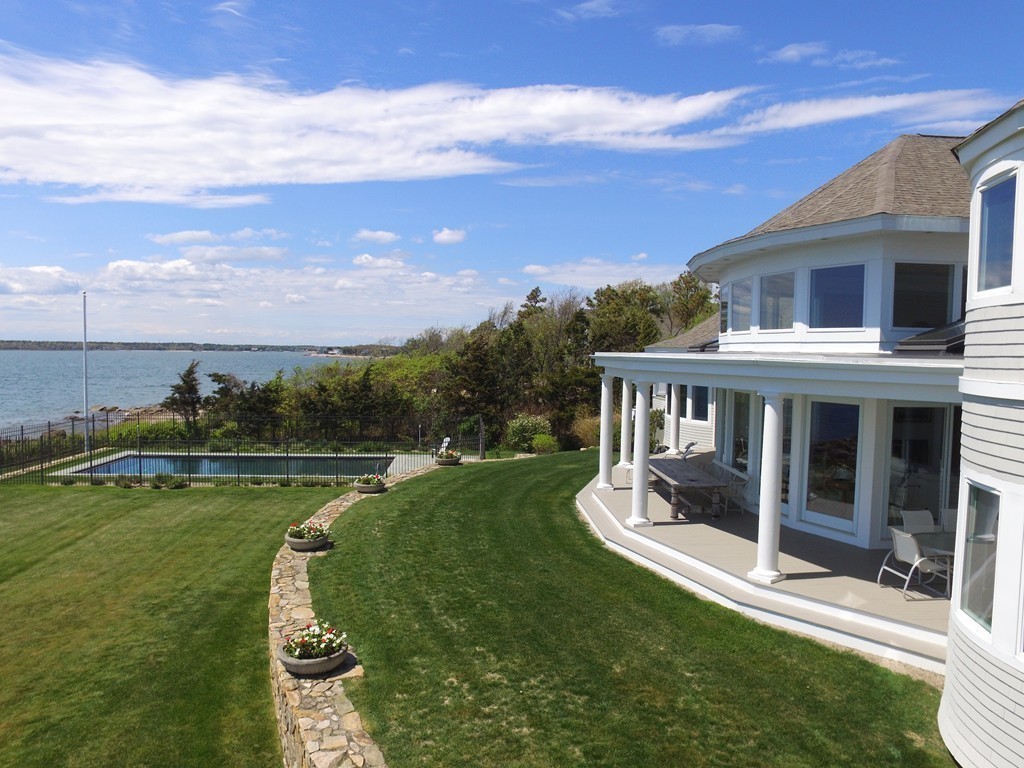 128 Point Road Marion, MA 02738 - Photo 14 of 25 a view of a swimming pool and lounge chairs in patio