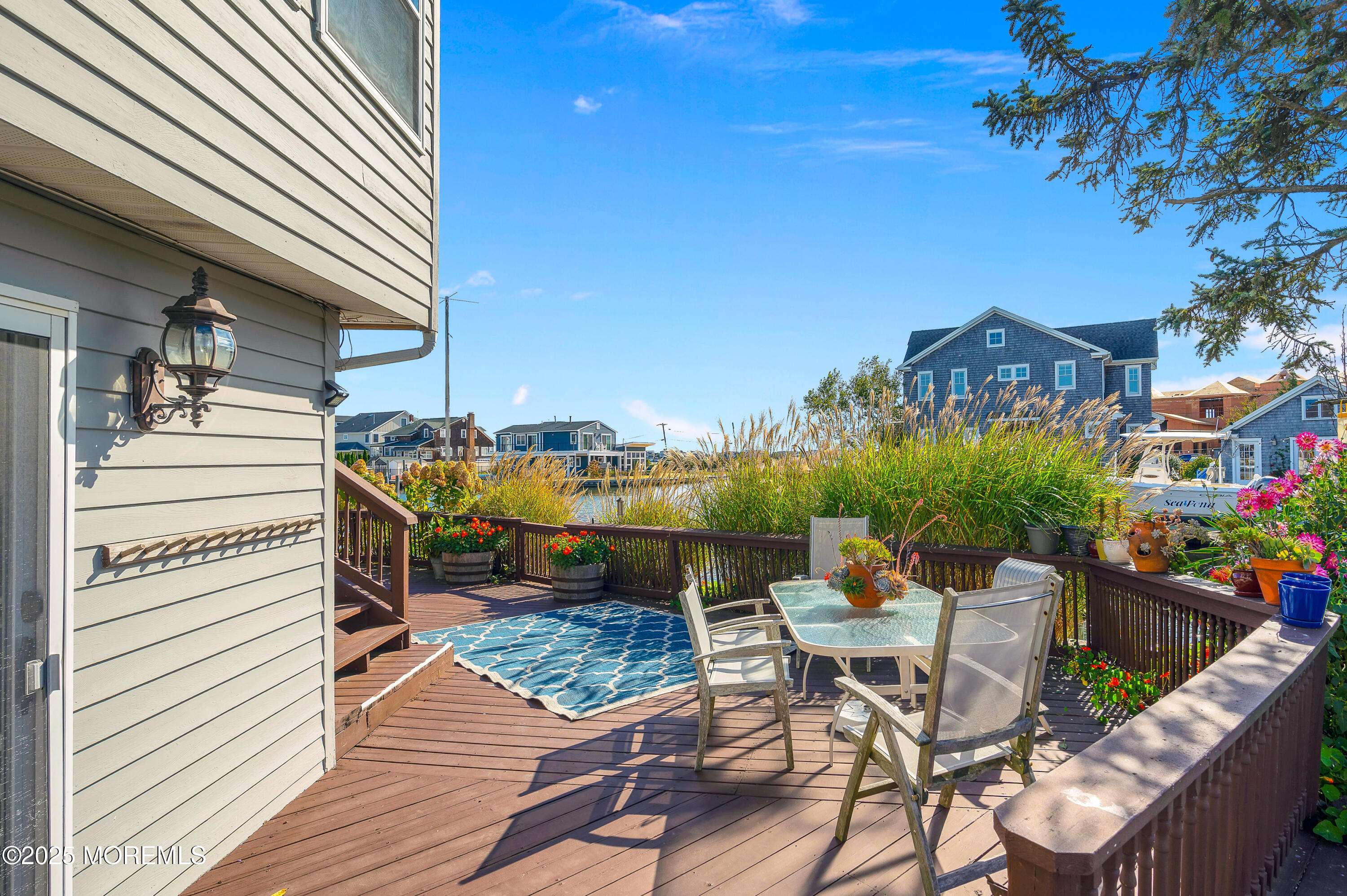 1700 Rue Mirador Point Pleasant, NJ 08742 - Photo 24 of 64 a roof deck with table and chairs and potted plants