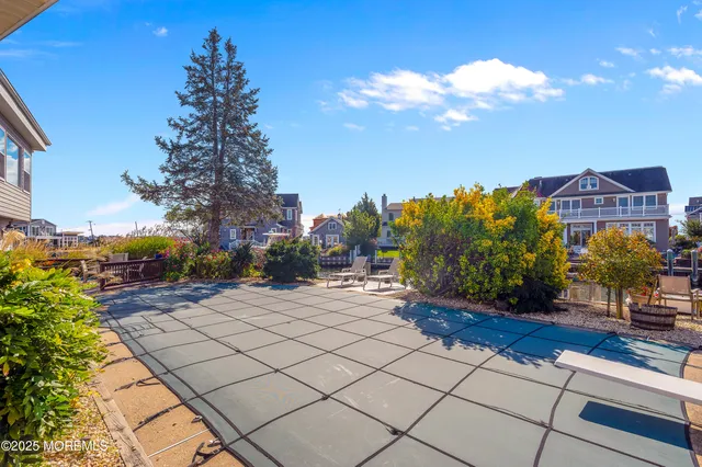 a view of a dining room with furniture and kitchen view
