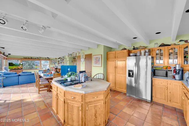 a bedroom with furniture and a large window