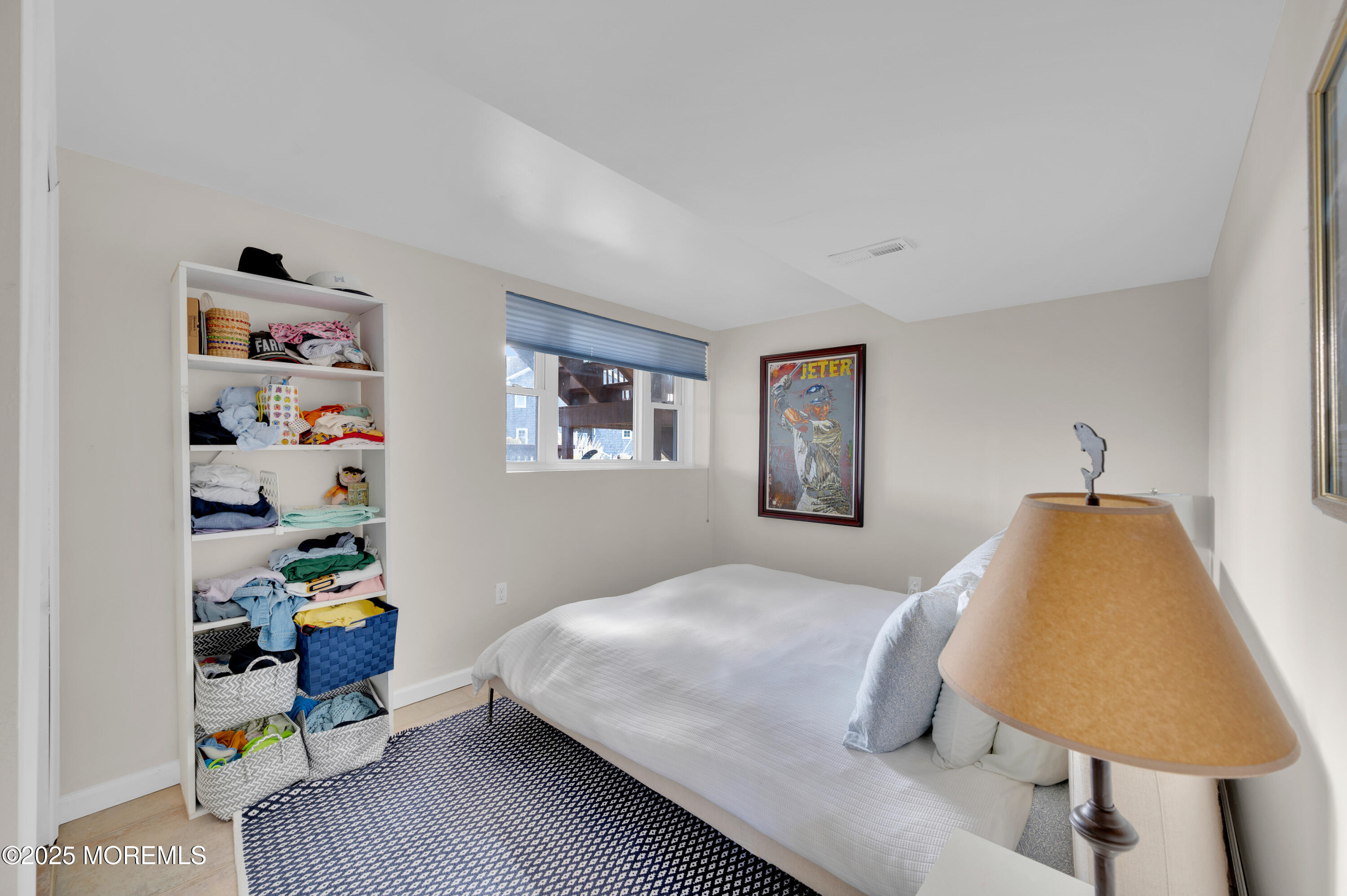 1700 Rue Mirador Point Pleasant, NJ 08742 - Photo 60 of 64 a bedroom with a bed a dresser and a book shelf