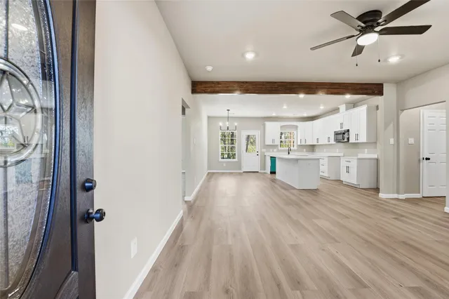 a view of kitchen with wooden floor and electronic appliances