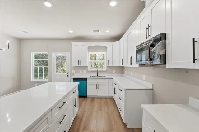 a kitchen with a sink stove and cabinets