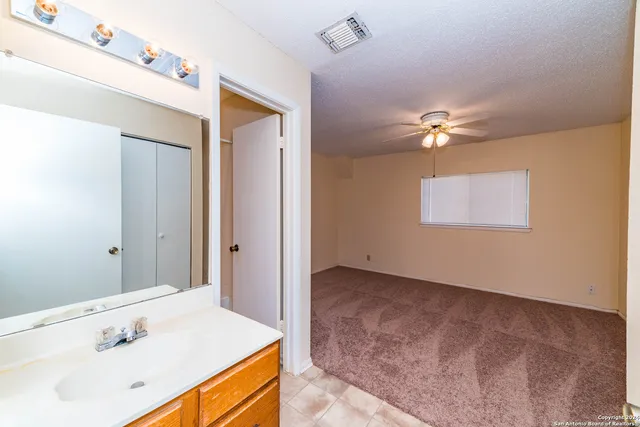 a bathroom with a sink a light fixture and a mirror