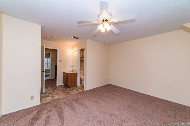 a view of a livingroom and a chandelier fan