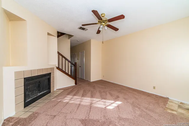 a view of an empty room with a fireplace