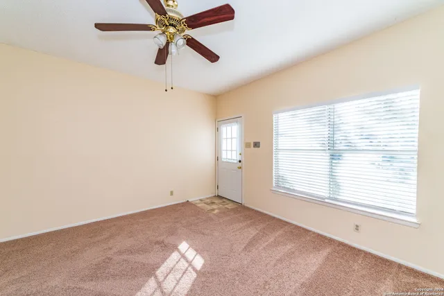 a view of room with window and ceiling fan