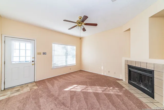a view of empty room with windows and fireplace