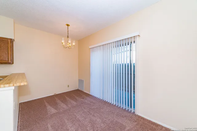 a view of a hallway with chandelier