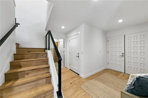 a view of entryway with wooden floor and stairs