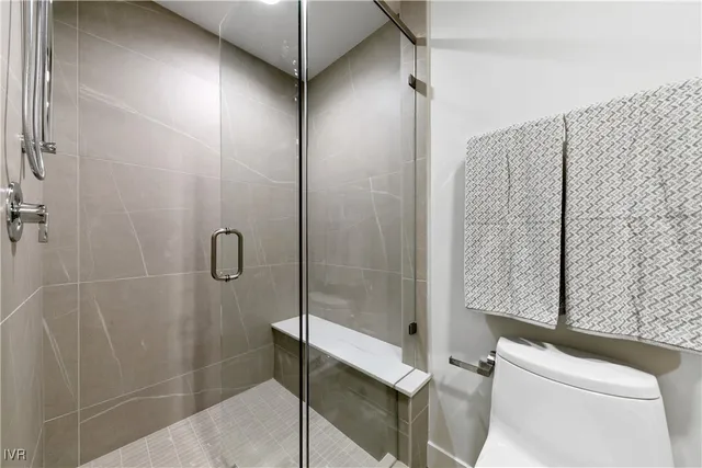 a bathroom with a shower and a toilet