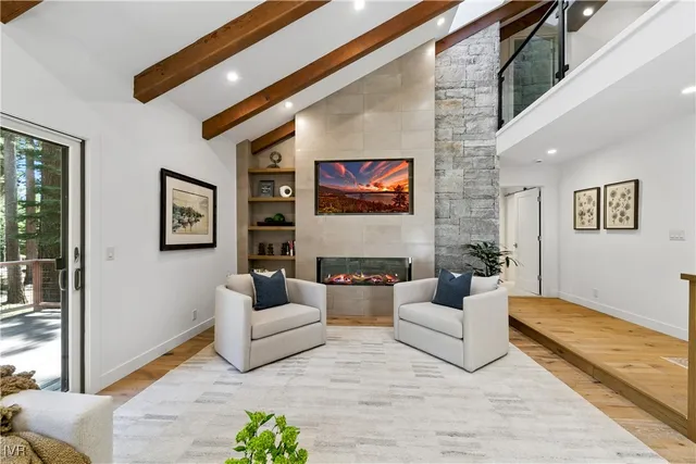 a living room with fireplace furniture and a rug