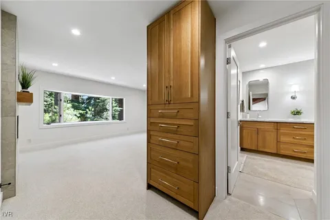 a bathroom with a tub a sink and a large mirror