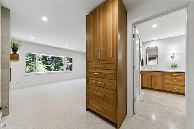 a bathroom with a tub a sink and a large mirror