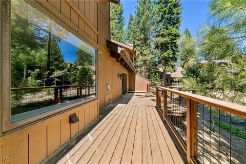 a view of balcony with wooden floor and fence