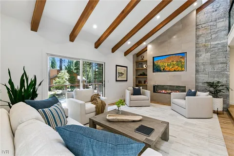 a living room with furniture and a floor to ceiling window