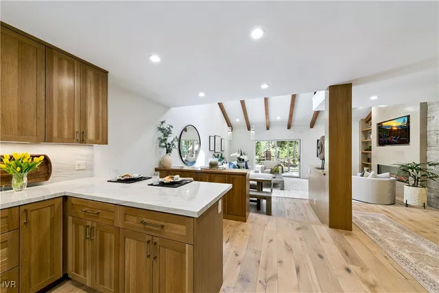 a kitchen with a sink cabinets and wooden floor