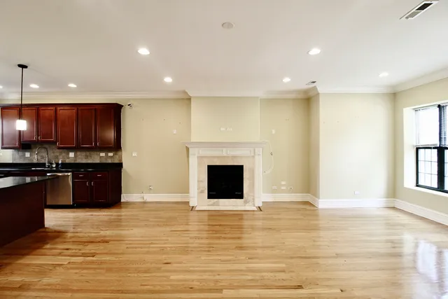 a view of a kitchen with kitchen island wooden floor and window