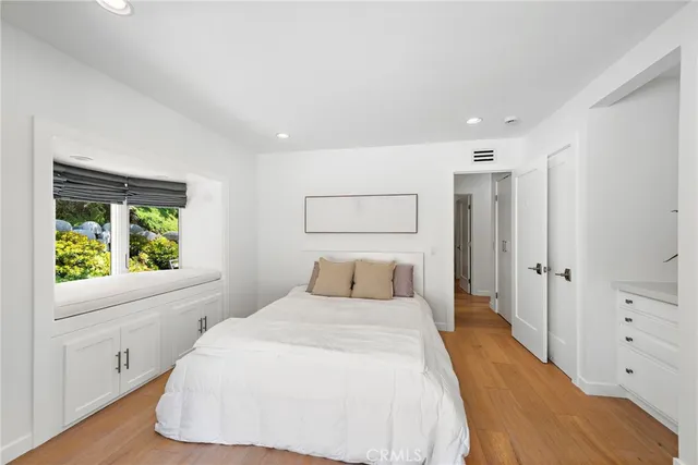 a bathroom with a double vanity sink a mirror and a bathtub