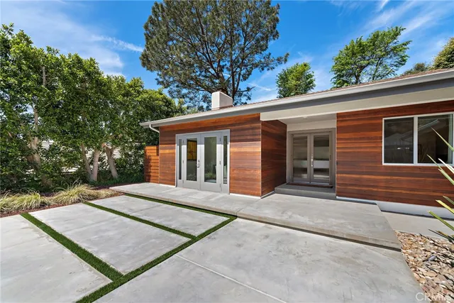 a front view of a house with a garden