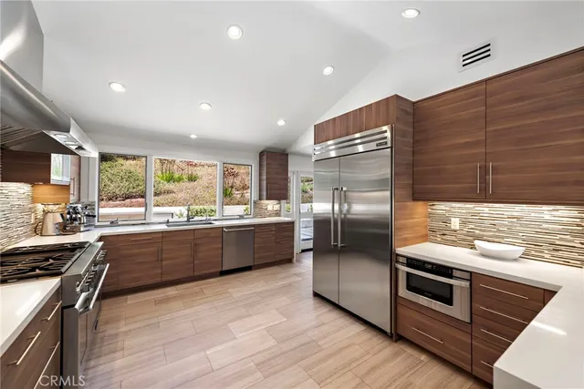 a kitchen with stainless steel appliances kitchen island granite countertop a large counter top