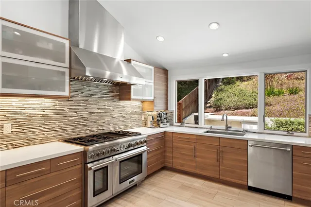 a kitchen that has a sink and a stove