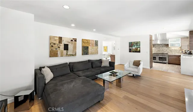 a living room with furniture and kitchen view