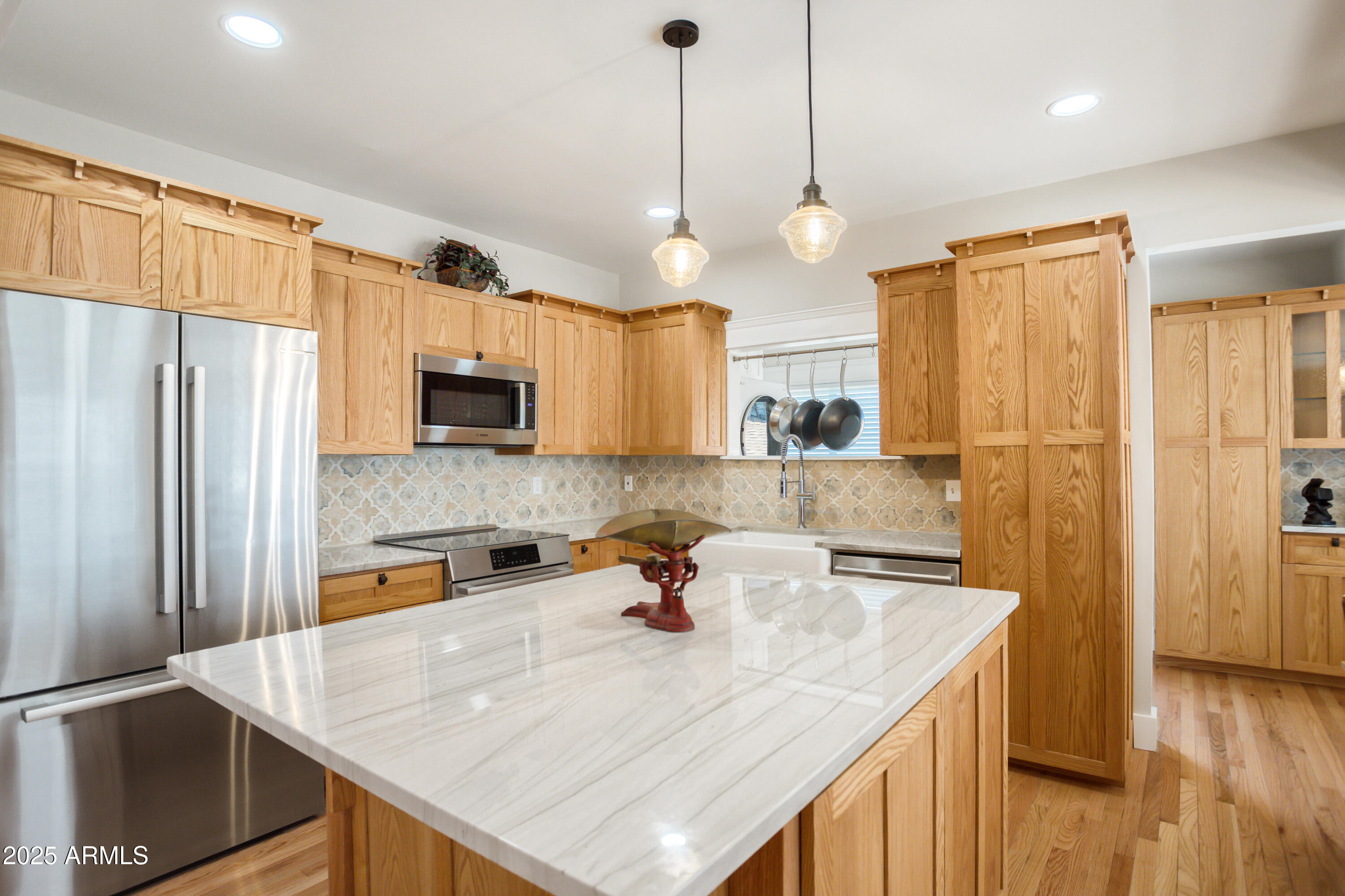 400 Powell Street Bisbee, AZ 85603 - Photo 16 of 57 a kitchen with stainless steel appliances granite countertop a sink a refrigerator and a stove