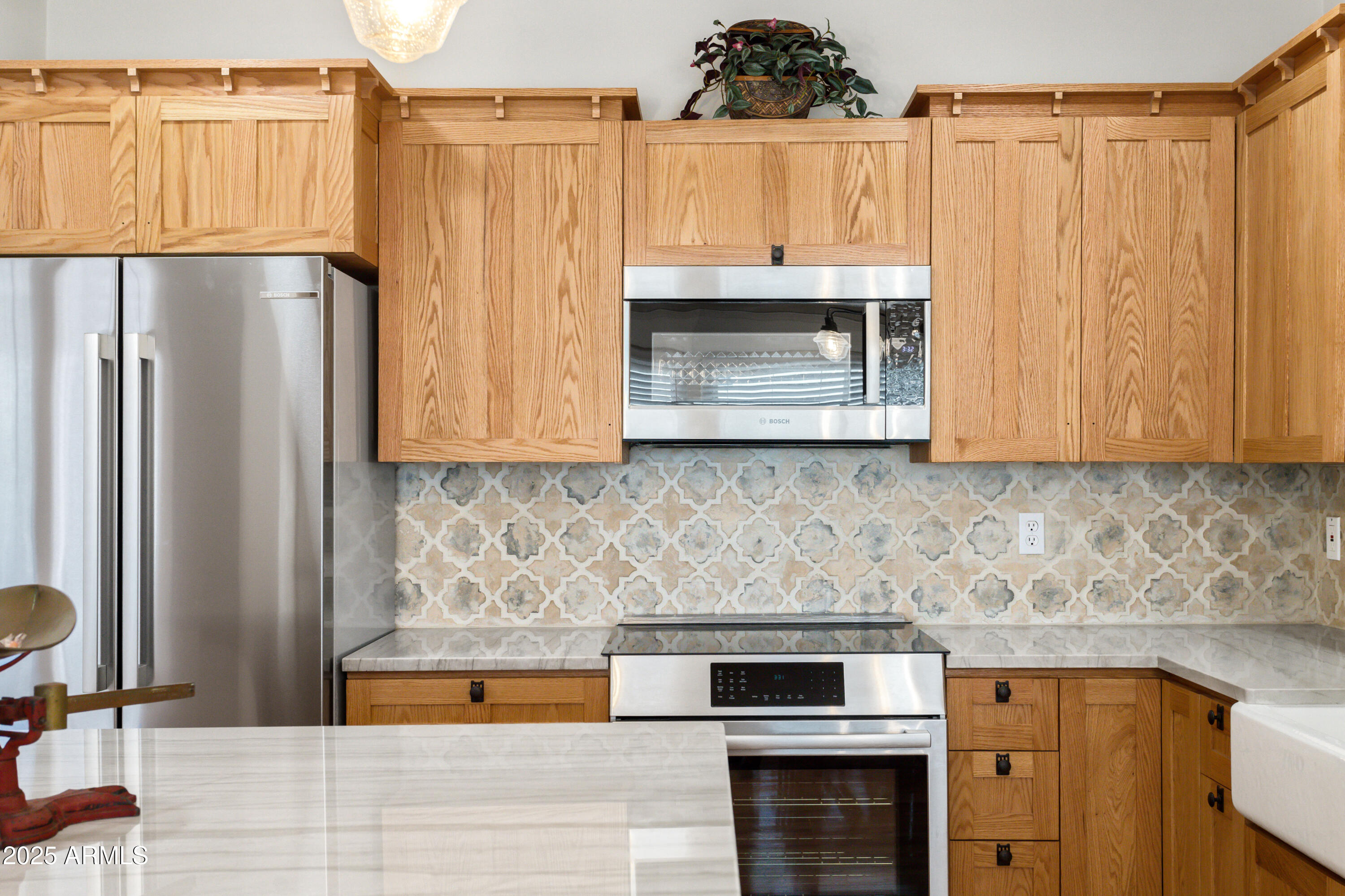 400 Powell Street Bisbee, AZ 85603 - Photo 19 of 57 a kitchen with stainless steel appliances wooden cabinets a stove and a refrigerator